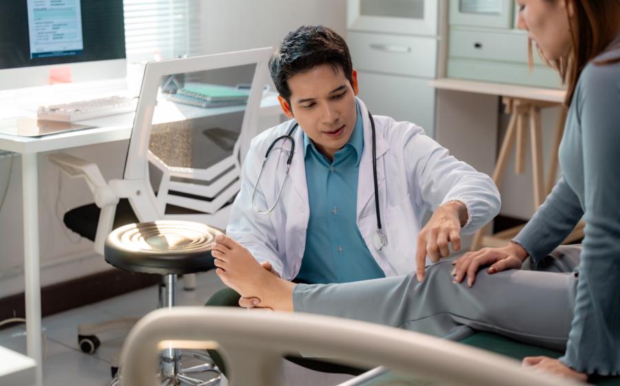 doctor examining knee joint