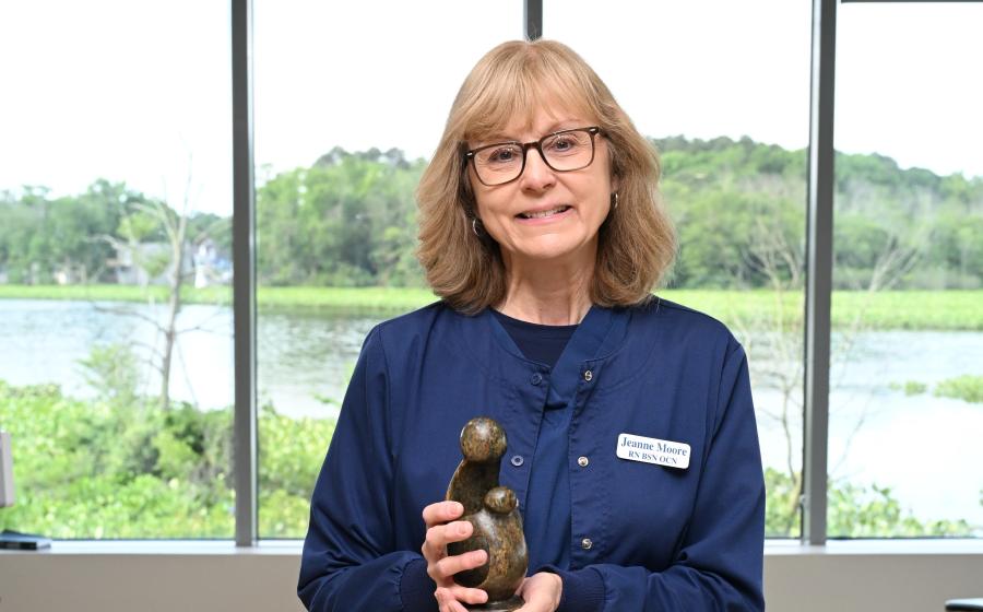 a female nurse holding her award 