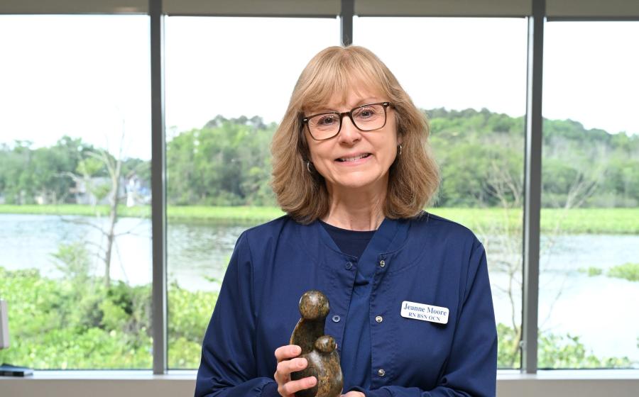 a female nurse holding her award 