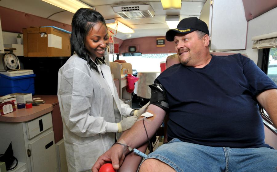 Man donating blood on a blood mobile