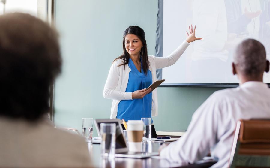 Female speaker presenting to a class