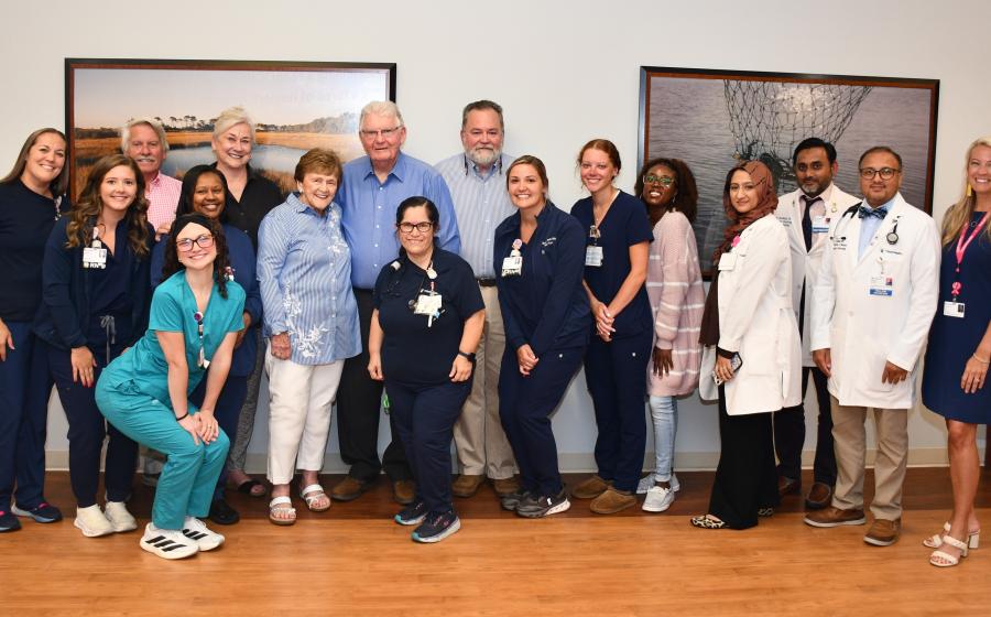 Group photo of caregivers and grateful family