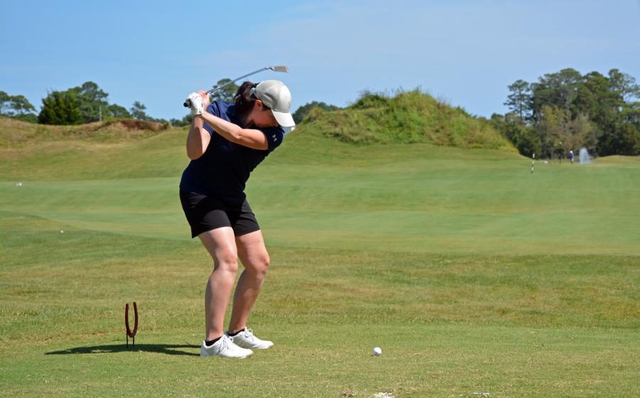 woman putting on green