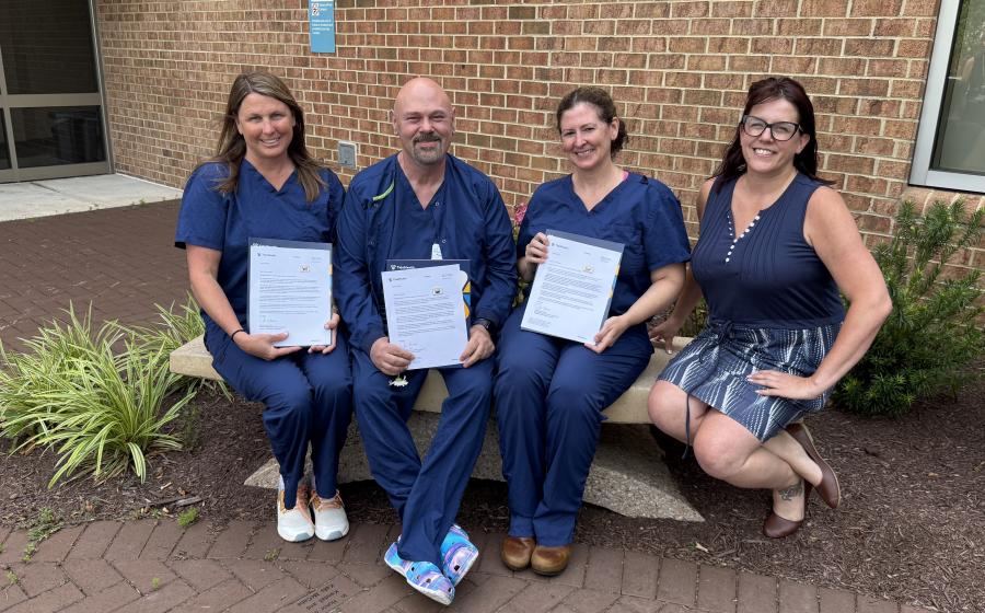 Three Guardian Angel recipients with a member of the TidalHealth Foundation, sitting on a bench outside