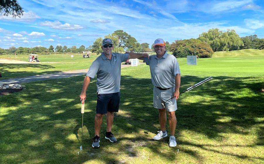 Warfield Memorial Golf classic, two men with golf clubs on a beautiful day