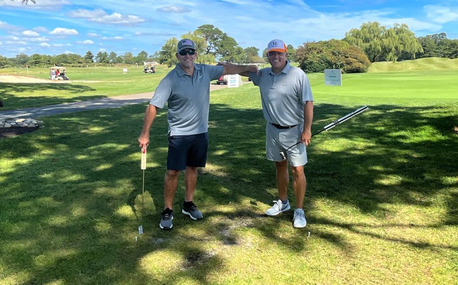 Warfield Memorial Golf classic, two men with golf clubs on a beautiful day